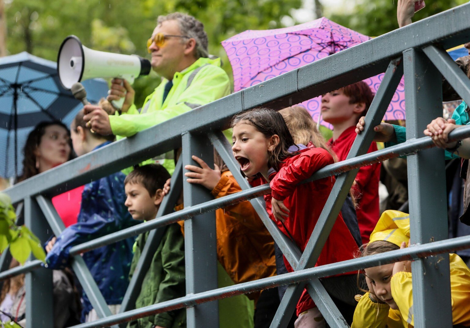 A crowd of Art Walk visitors gathered along the bridge and river path